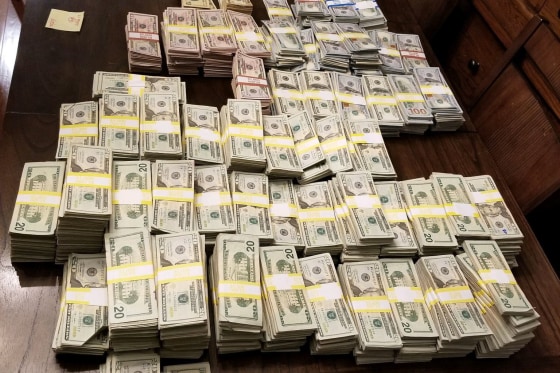 Law enforcement officers seized $900,000 during a search of Julie DeVuono's home. She and Marissa Urraro are accused of selling fake Covid-19 vaccine cards.