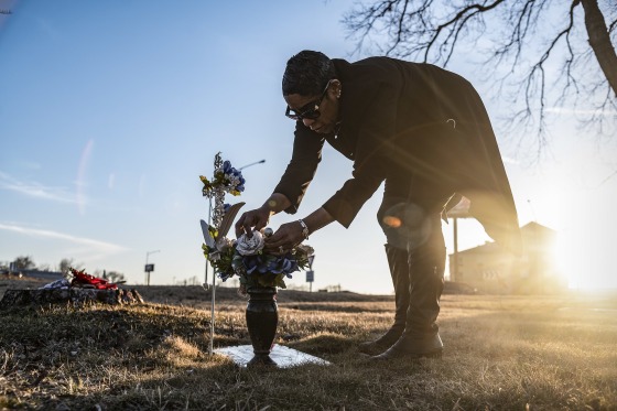 Doressia McKee tends to the gravesite of her son, Freddie McKee, in Columbia, Mo.