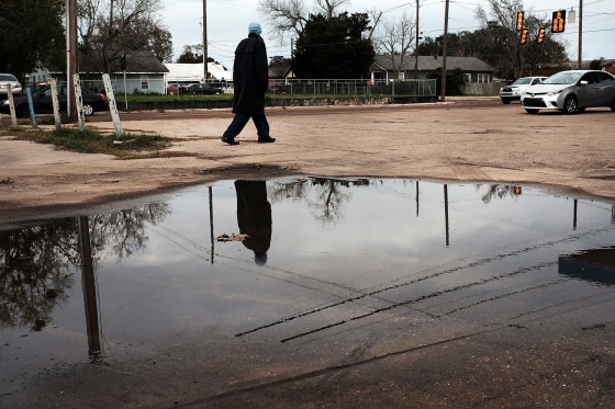 Image: A man walks through town on in Biloxi, Miss., on Jan. 3, 2016.
