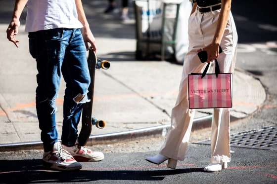 A pedestrian carries a Victoria's Secret shopping bag while waiting to cross a street in New York on Sept. 25, 2019.