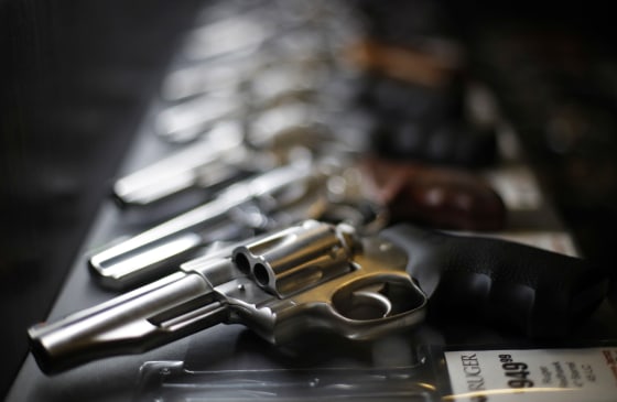 Handguns for sale are lined up in a display case at Frontier Justice in Lee's Summit, Mo., on Dec. 21, 2108.