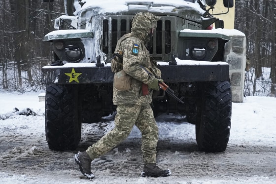 Image: A Ukrainian serviceman walks by a deactivated Russian military multiple rocket launcher on the outskirts of Kharkiv, Ukraine, on Feb. 25, 2022.