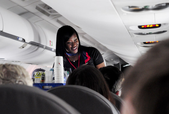 An American Airlines flight attendant serves drinks to passengers after departing from Dallas/Fort Worth International Airport in Texas on Oct. 3, 2017.