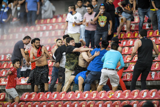 Fans clash during a Mexican soccer league match between the host Queretaro and Atlas from Guadalajara, at the Corregidora stadium, in Queretaro, Mexico, on March 5, 2022.