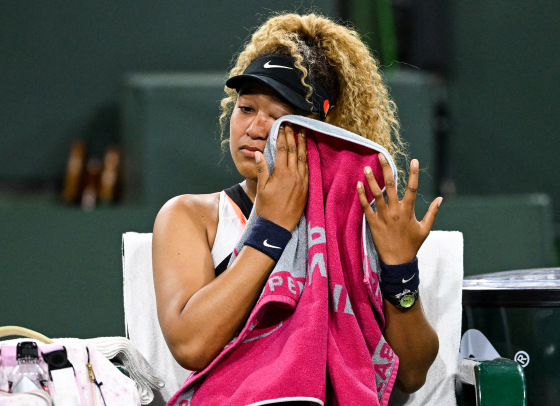 Naomi Osaka wipes her face as she talks to referee Claire Wood after a spectator disrupted play at the Indian Wells Tennis Garden on March 12, 2022.