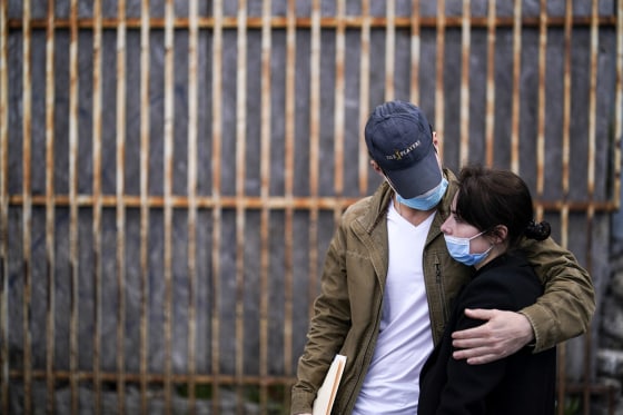 A woman from Ukraine stands at the border with her fiancé from the United States as she waits to ask for asylum on March 10, 2022, in Tijuana, Mexico.
