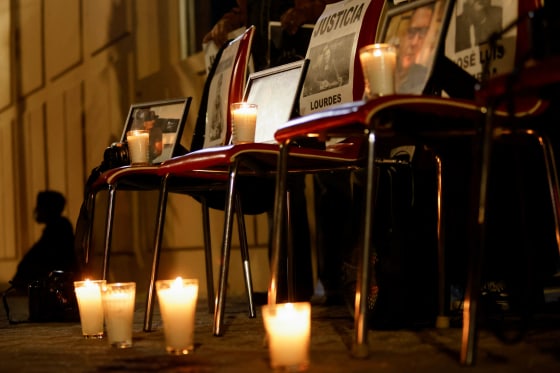 Candles and photos of deceased journalists are placed outside the Attorney General's office in Ciudad Juarez, Mexico, on Feb. 14, as part of a protest by journalists who demand justice and protection from the federal government.