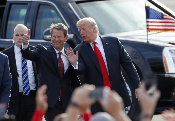 Then-President Donald Trump talks with then-gubernatorial candidate Brian Kemp before a rally in Macon, Ga., on Nov. 4, 2018.