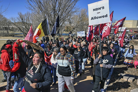 Candi Brings, bottom left, and hundreds of other people march from Memorial Park to the Andrew W. Bogue Federal Building in Rapid City, S.D., on Wednesday.