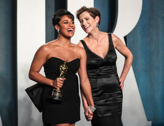 Ariana DeBose holds her Oscar while posing for pictures with Sue Makkoo during their arrival at the Vanity Fair Oscar party in Beverly Hills, Calif., on Sunday.