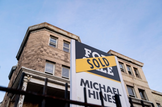 A sold banner is displayed over a For Sale sign in front of a house in Washington, D.C, on March 14, 2022.