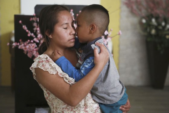 A woman embraces a child at the Good Samaritan shelter