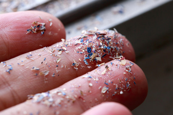 Close up side shot of microplastics lay on people hand.