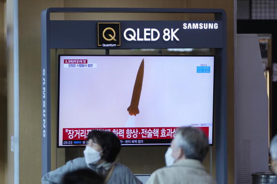 A TV screen shows a news program reporting about a test-firing of a newly developed tactical guided weapon, at a train station in Seoul, South Korea on Sunday.