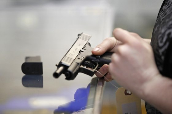 A person holds a Glock handgun