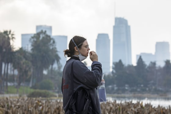 A woman takes a PCR COVID-19 test