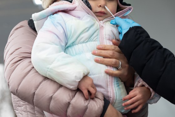 Image: A child receives a Covid-19 test in Philadelphia on Dec. 30, 2021.