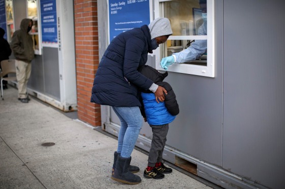 A child receives a COVID test in New York on Dec. 23, 2021. (Anna Watts/The New York Times)