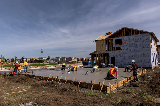 Image: Contractors work on concrete slabs at a housing development in Antioch, Calif., on March 31, 2022.