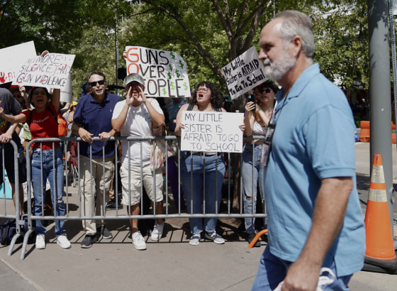 Protesters shout at attendees of the NRA annual meeting in Houston on Friday.