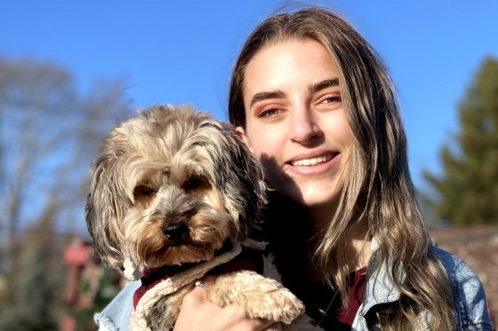 Alexis Spence holds her family dog, Draco.