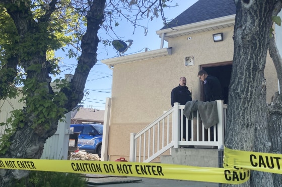 Police stand at the scene of an overnight fire that severely damaged a building that was being renovated to house a new abortion clinic in Casper, Wyo., on May 25, 2022.