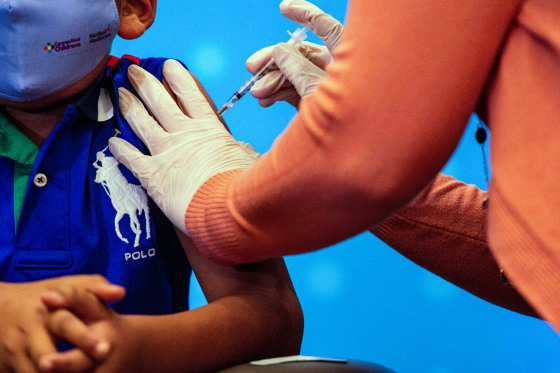 A six-year-old child receives the Pfizer-BioNTech Covid-19 Vaccine.