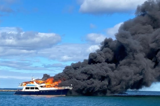 The yacht engulfed in flames near New Castle, N.H., on Saturday in a Coast Guard photo. 