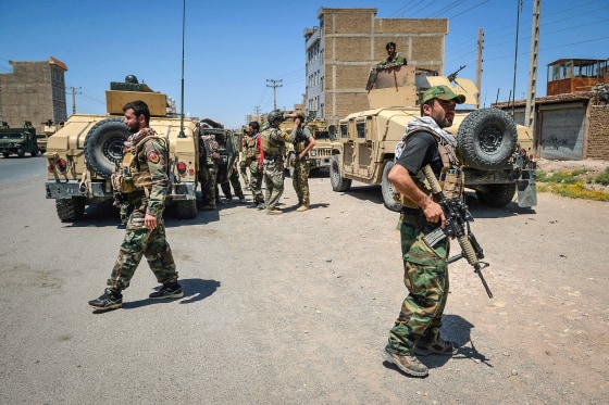 Afghan National Army commando forces walk along a road amid ongoing fighting between Taliban and Afghan security forces in the Enjil district of Herat province on Aug. 1, 2021.