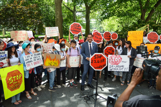 Councilmember Christopher Marte, center, and Lai Yee Chan, center left, at a press conference on May 31, 2022, about an upcoming bill to abolish the 24 hour workday in the home care industry.