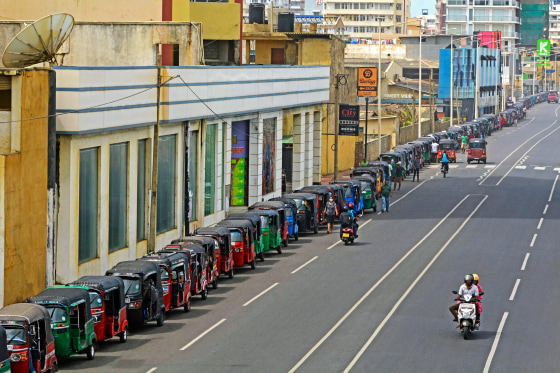 Image: Autorickshaw drivers queue along a street to buy gasoline from a fuel station in Colombo, Sri Lanka, on July 6, 2022.