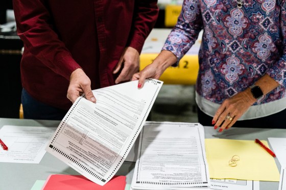 People hand count presidential election ballots during an audit at the Gwinnett County Voter Registration office in Lawrenceville, Ga., on Nov. 13, 2020.