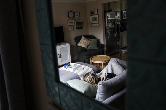 Eve Efron, who has been struggling with long Covid, frequently has to rest on the couch in her home in Fairfax, Va., on Feb. 3, 2022. Her symptoms include significant fatigue, brain fog, anxiety and depression.