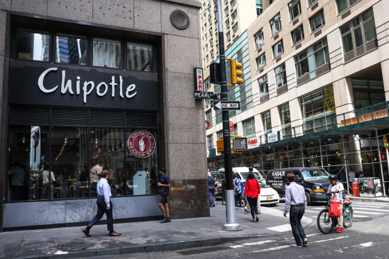 Image: People walk past a Chipotle store on Aug. 10, 2022 in New York.