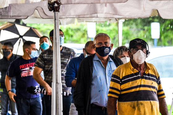 Voters wait in line to cast their ballots during early voting at the Miami-Dade County Election Department in Miami on Oct. 21, 2020.