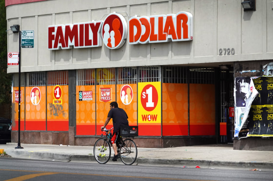 A cyclist rides past a Family Dollar store