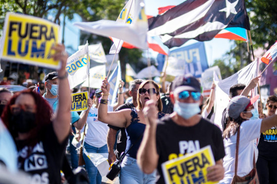 People protest outside the headquarters of Luma Energy