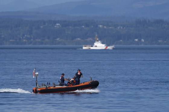 A pair of Coast Guard vessels search the area near Seattle where a chartered floatplane carrying 10 people crashed Sunday evening. The search was called off Monday afternoon.