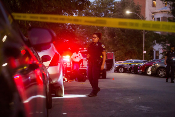 New York Police Department officers investigate the scene of a shooting