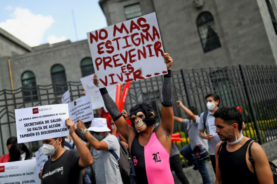 Activists hold signs during a protest to call for a stronger response by the government to the monkeypox crisis in Mexico City.
