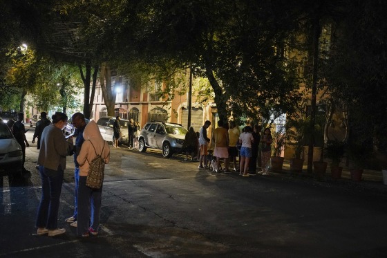 Mexico City residents gather outside after an earthquake was felt in Mexico City on Thursday.