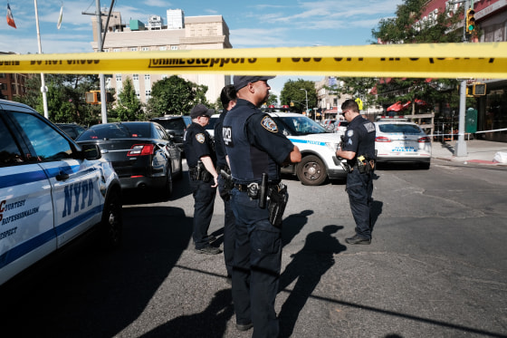 Police gather at the scene of a shooting