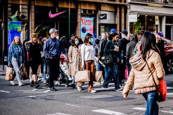 People carry shopping bags in New York on Oct. 24, 2021.