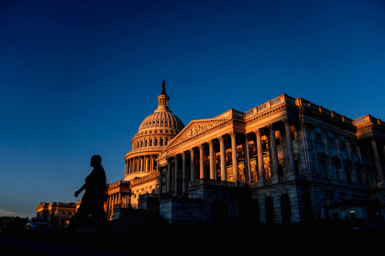 Image: A pedestrian walks past the US Capitol