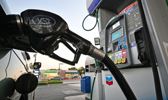 A nozzle pumps gasoline into a vehicle at a gas station in Los Angeles on Oct. 5, 2022.