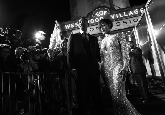 Image: A black and white photo of Will Smith and Jada Pinkett Smith at a screening of "Concussion" in Los Angeles
