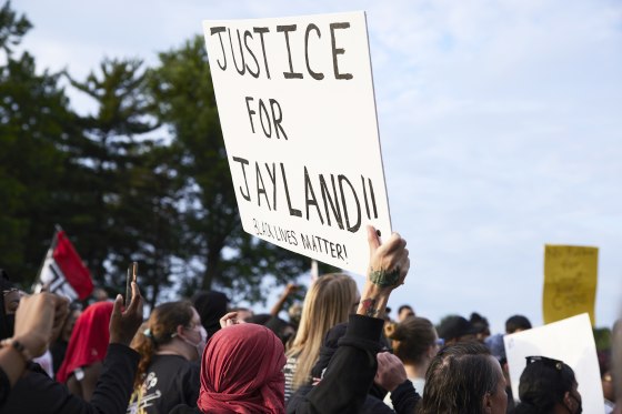 A demonstrator holds a sign during a vigil in honor of Jayland Walker, in Akron, Ohio, on July 8, 2022. Walker was shot and killed by members of the Akron Police Department on July 3, 2022.