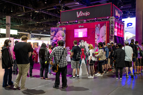 Fans gather around the VShojo booth to see the Vtuber Projekt Melody.