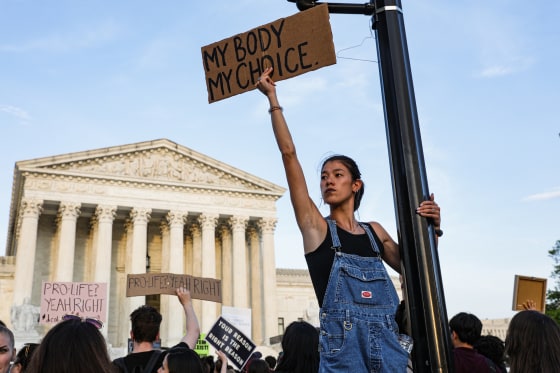 An abortion rights supporter holds a sign that reads, "My Body, My Choice" outside the Supreme Court in May 2022.
