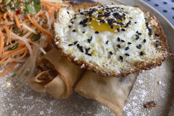 Image: A vegan chorizo egg roll and a meat chorizo egg roll topped with a fried egg and a papaya and carrot slaw at BOCA restaurant in Tucson, Ariz.
